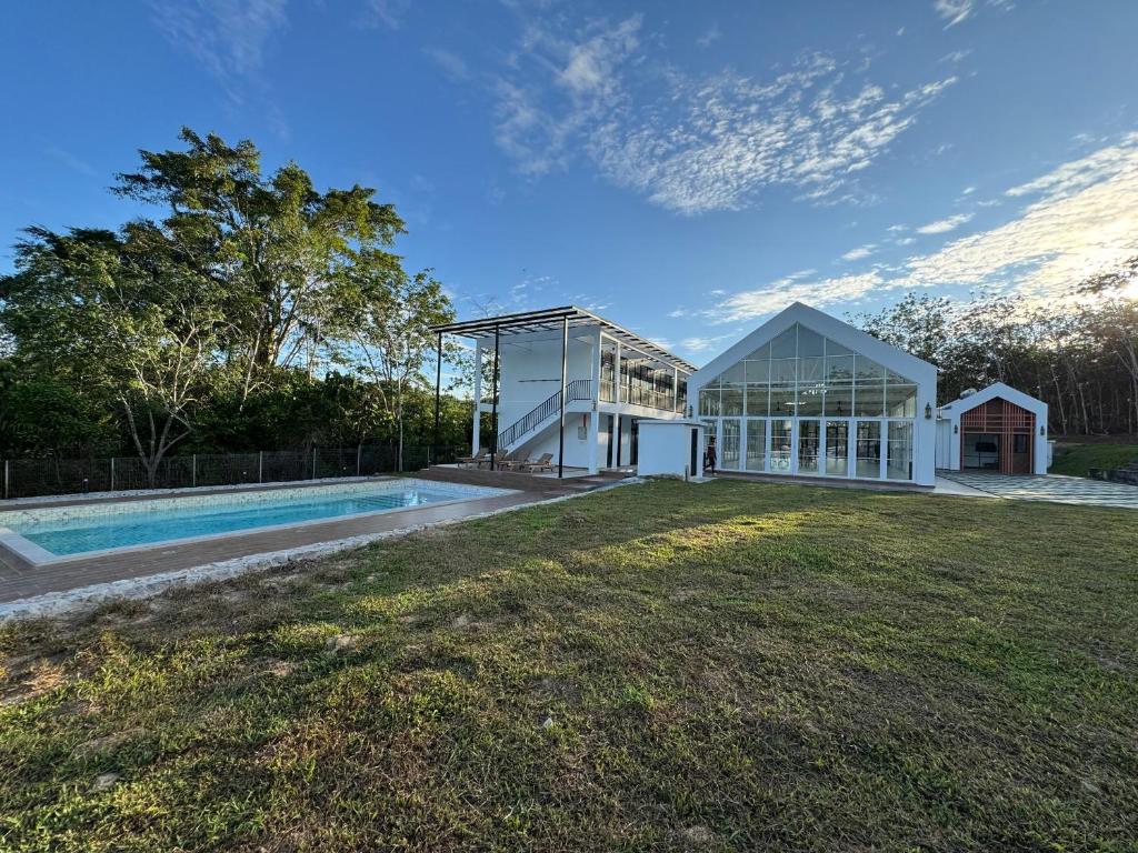 a house with a swimming pool in the yard at The Outskirt Melaka in Kampong Lendu