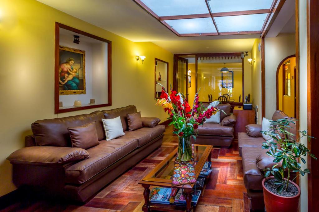 a living room filled with furniture and a large window at El Virrey Boutique in Cusco