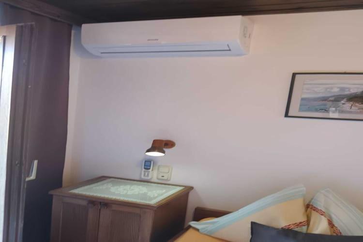 a room with a room with a bed and a fan at Guest House Villa Daniel - Two Bedroom Apartment with Balcony in Omiš