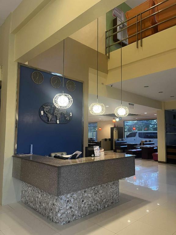 a lobby with a reception counter with lights at Kojo Hotels Premier in Tagum