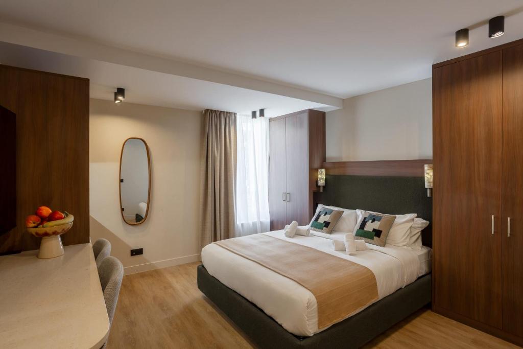 a hotel room with a large bed and a table at Sol St Mande - 2 pers- 32 in Saint-Mandé