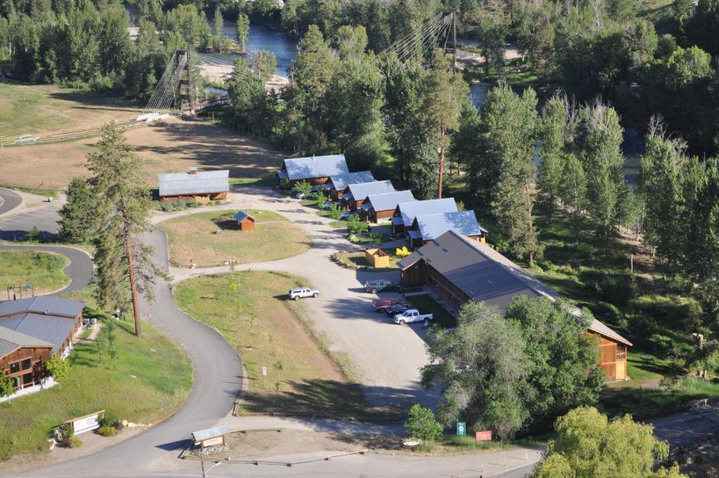 an aerial view of a building with a road and trees at Methow River Lodge in Winthrop