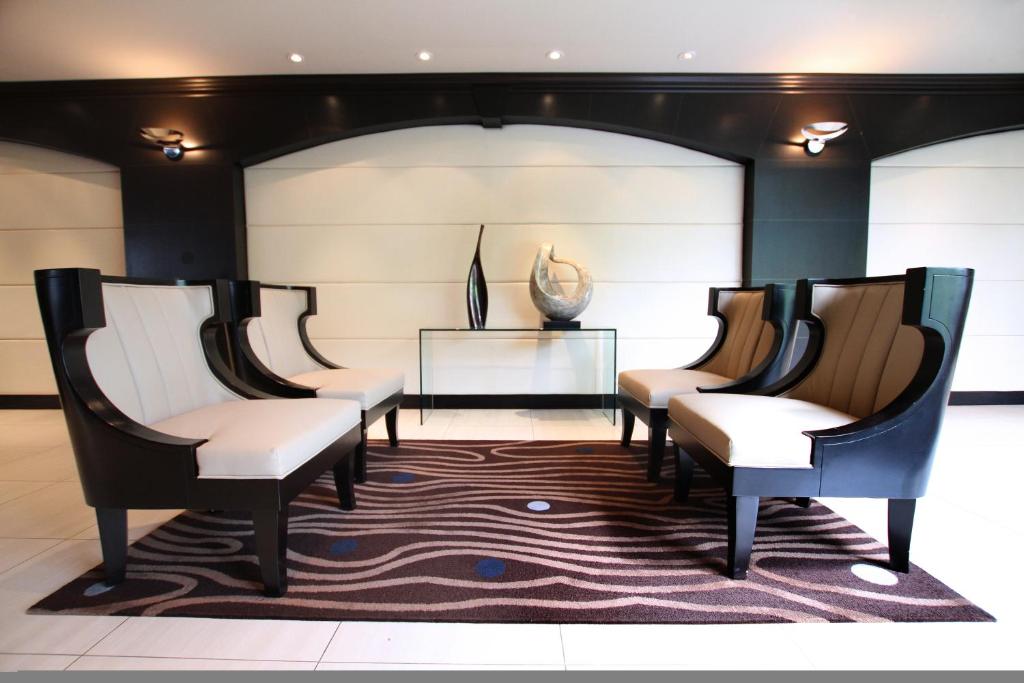 a row of chairs in a room with a table at Granville Island Hotel in Vancouver