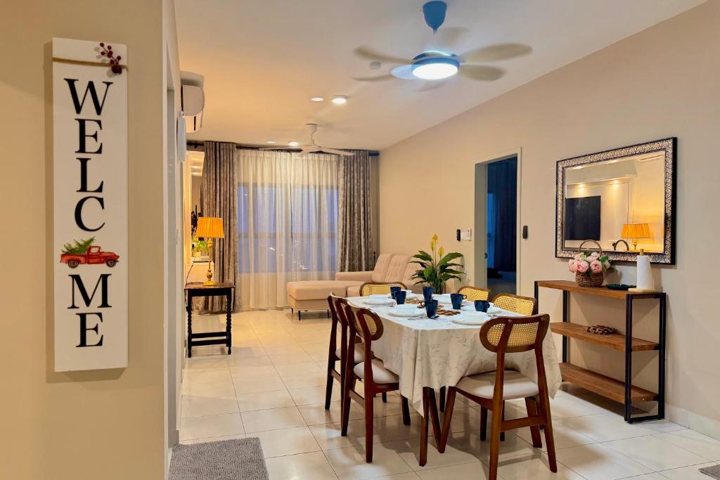 a dining room and living room with a table and chairs at Arena Residence Sepang KLIA With Netflix by Westay Hospitality in Kampong Melot