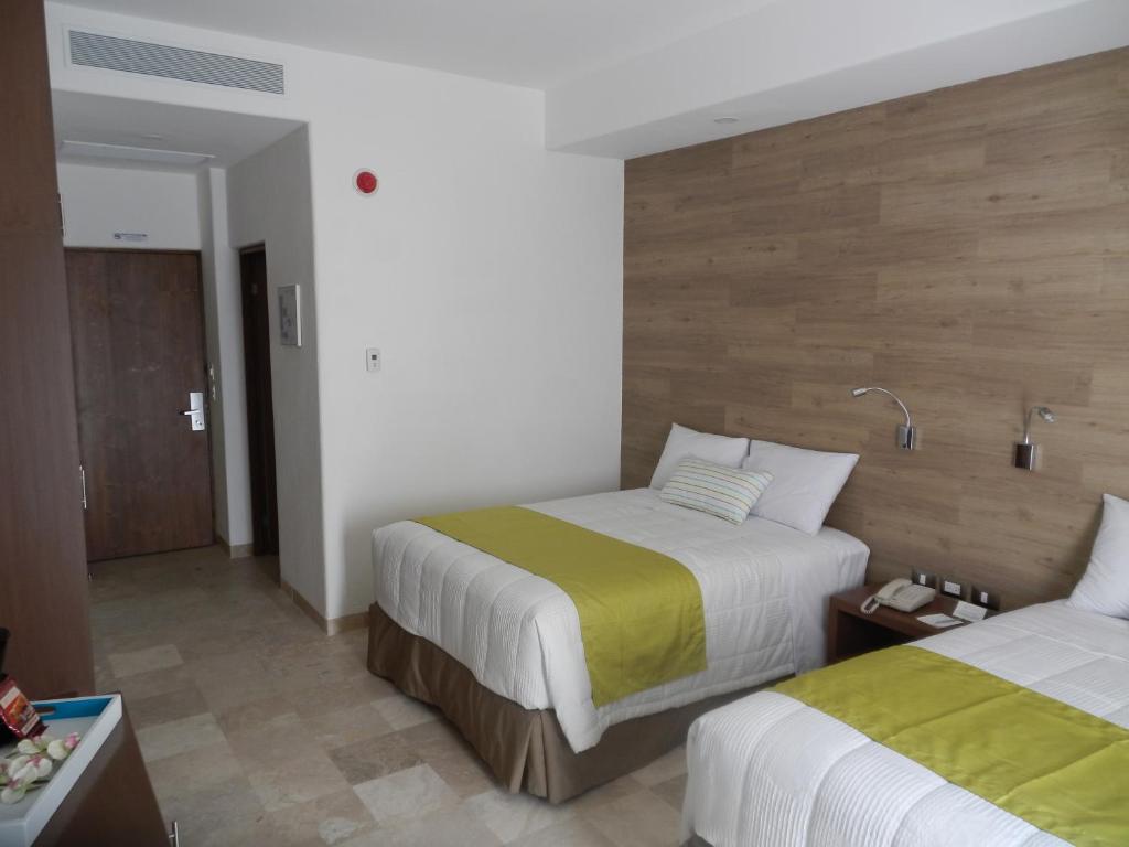 Postel nebo postele na pokoji v ubytování Hotel Catedral La Paz
