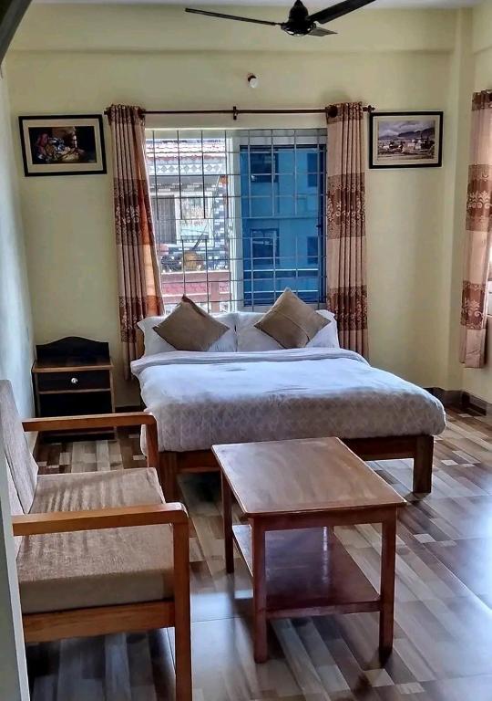 a bedroom with a bed and a large window at Northern Suite Home in Pokhara