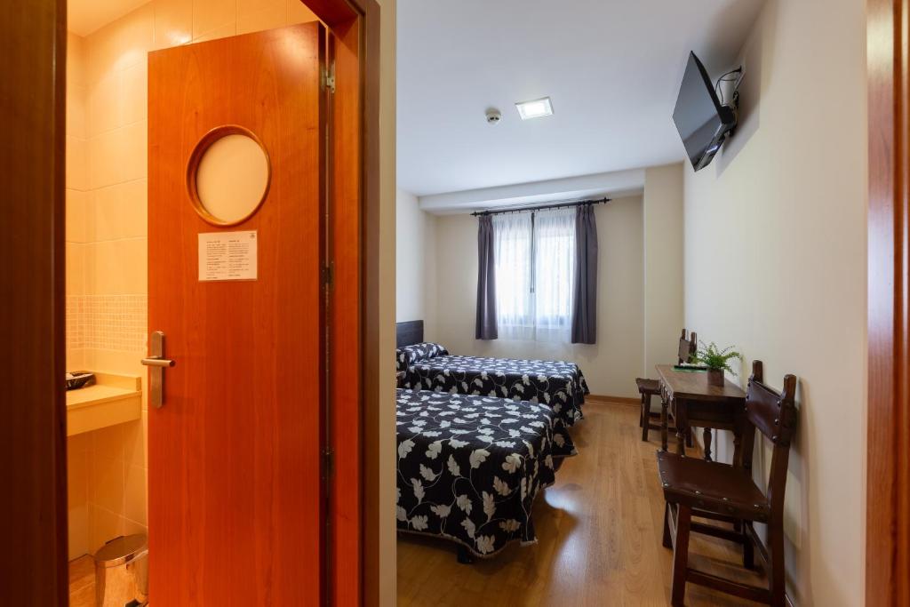 Cama o camas de una habitación en Hostal LaPerdiz