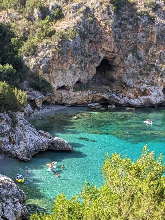a group of people swimming in the water in a river at Camerota Basic Appartamenti in Lentiscosa