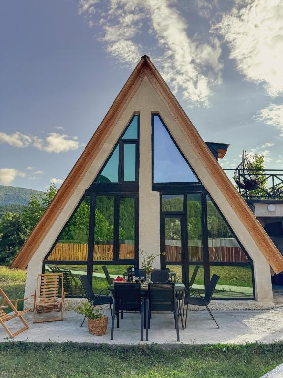 a barn style house with a table and chairs at Cottage Velli in Saketsia