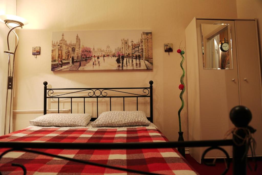 a bedroom with a bed with a checkered blanket at Loft Hostel Minsk in Minsk
