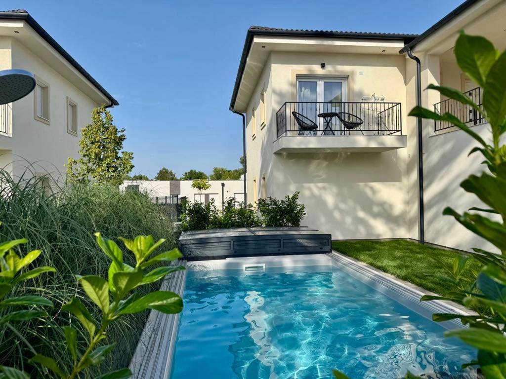 a swimming pool in the backyard of a house at Nexus apartman in Siófok