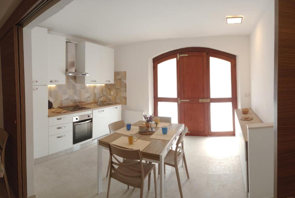 a kitchen with a table with chairs and a dining room at Casa Pie' di Monte Refuge in Bisegna