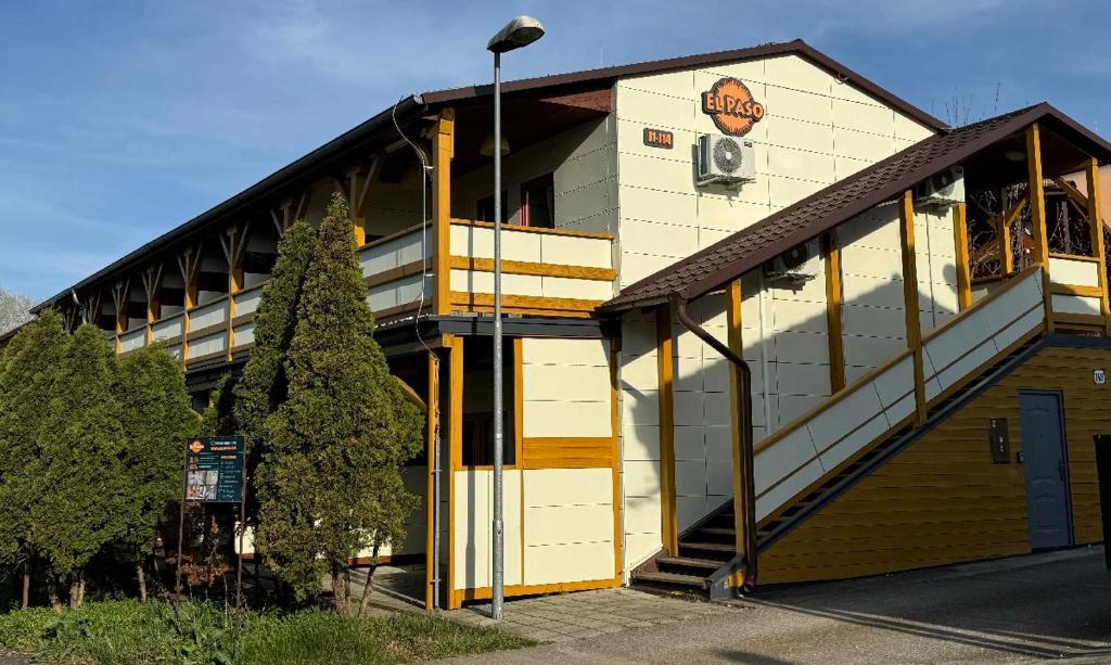 a building with a sign on the side of it at EL PASO ubytovanie chata J9 - J13 v areáli kúpaliska in Štúrovo