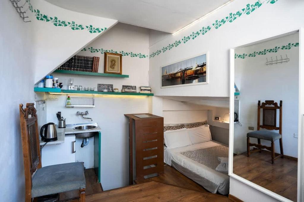 a small room with a bed and a sink at 12 Duomo - Monolocale centrale e silenzioso in Florence