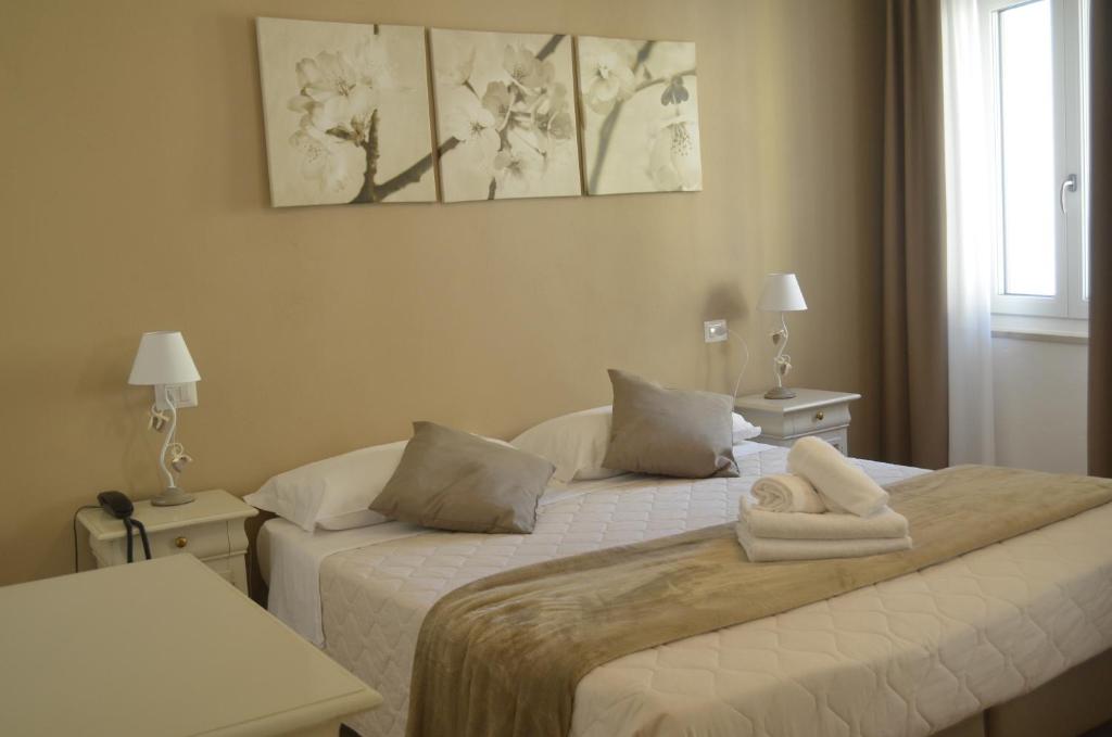 Postel nebo postele na pokoji v ubytování Hotel RivaMia