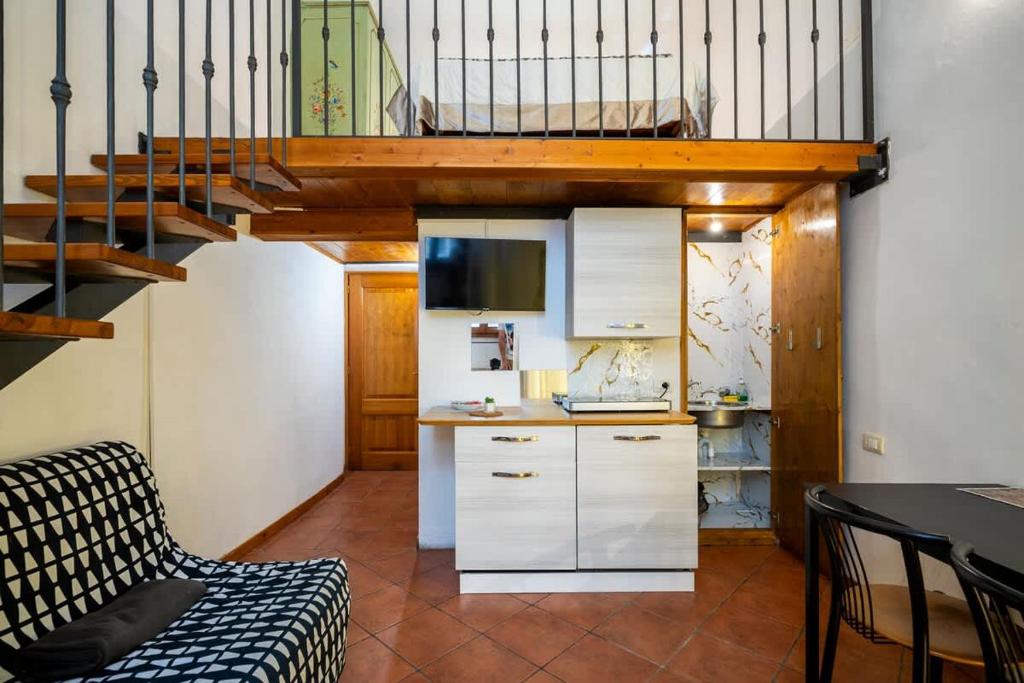 a living room with a staircase and a kitchen at 2 - Monolocale silenzioso a due passi dal centro in Florence