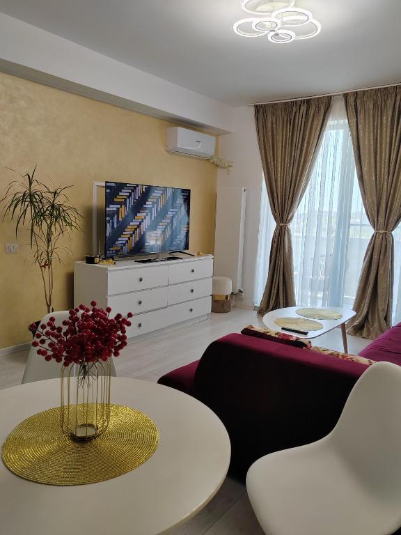 a living room with a couch and a table at DML Apartment in Mamaia Sat/Năvodari