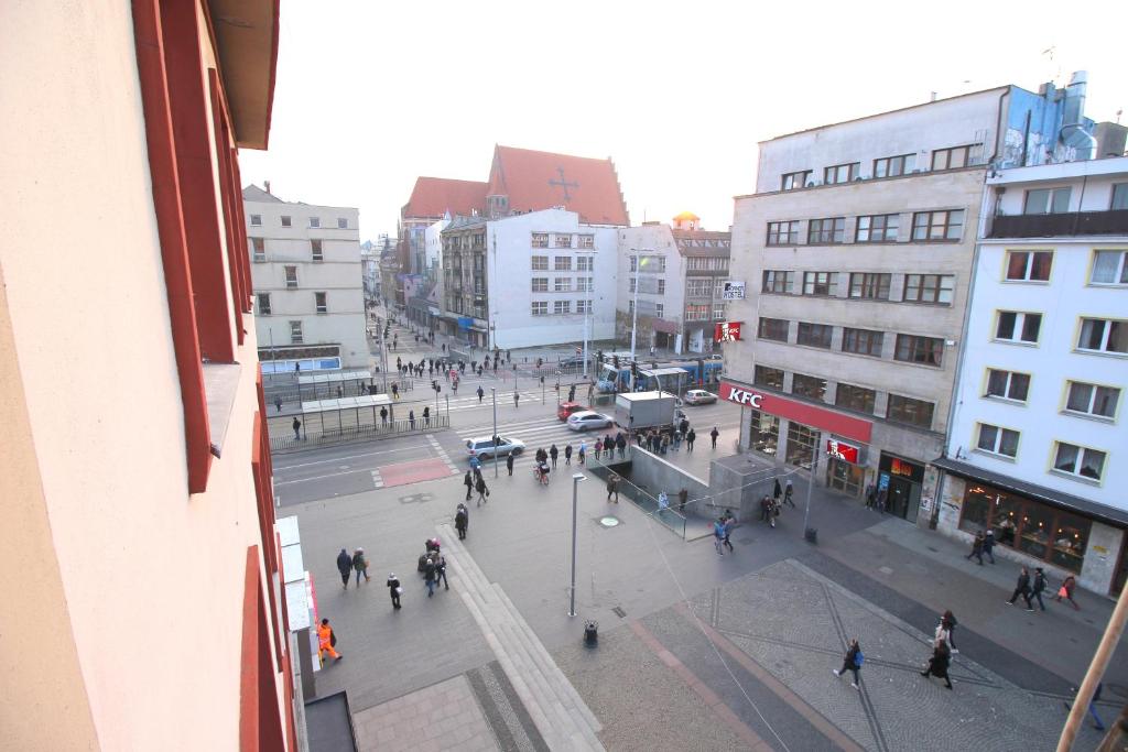 a group of people walking around a street in a city at HappyEstate Apartments 3 min do Rynku in Wrocław