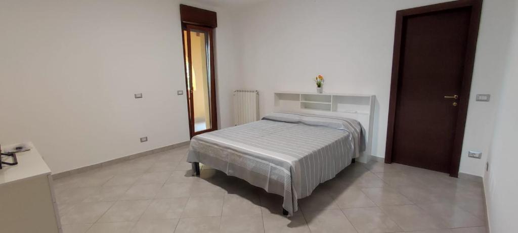 a bedroom with a bed in a white room at Bed and Bike in Vasto
