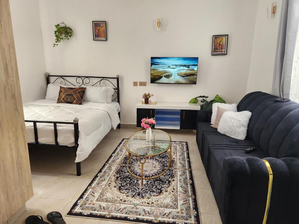 a living room with a couch and a table at Keshi homes ruaka in Kiambu
