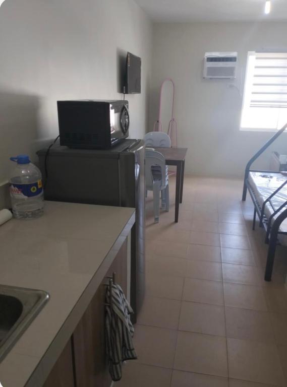 LagunaにあるRics Remarkable and Radiant Home in Dumaguete City - Marina Spatial B842のキッチン(テーブル、電子レンジ付)
