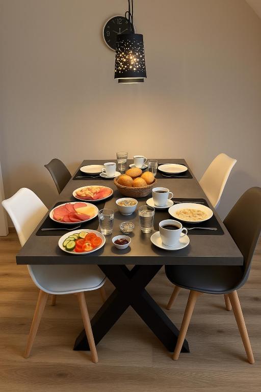 a black table with plates of food on it at Ferienwohnung Weseker Auszeit in Borken