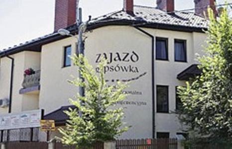 a building with writing on the side of it at Hotel Rypsówka in Nowy Sącz