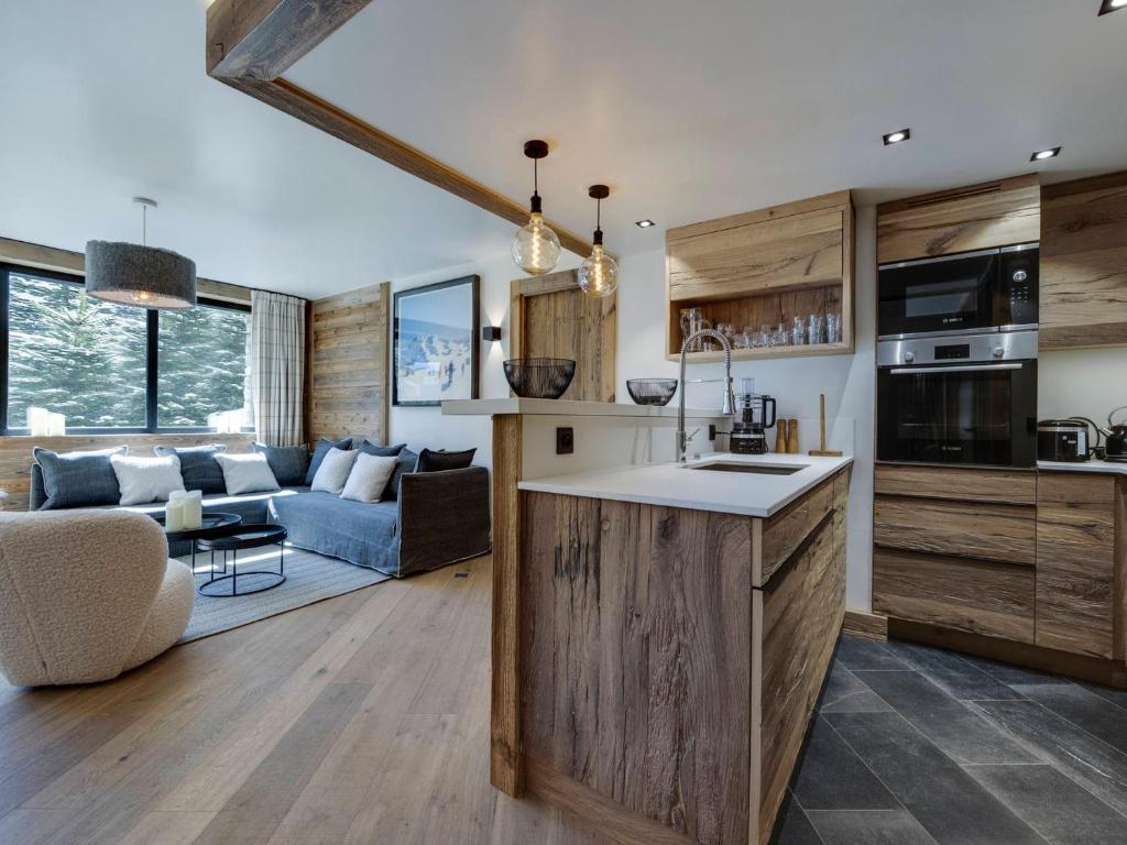 a kitchen and living room with a couch and a table at Appartement 95m², Sud-Est, Jacuzzi, Val d'Isère, 4 Suites, Parking, Animaux OK - FR-1-567-73 in Val dʼIsère