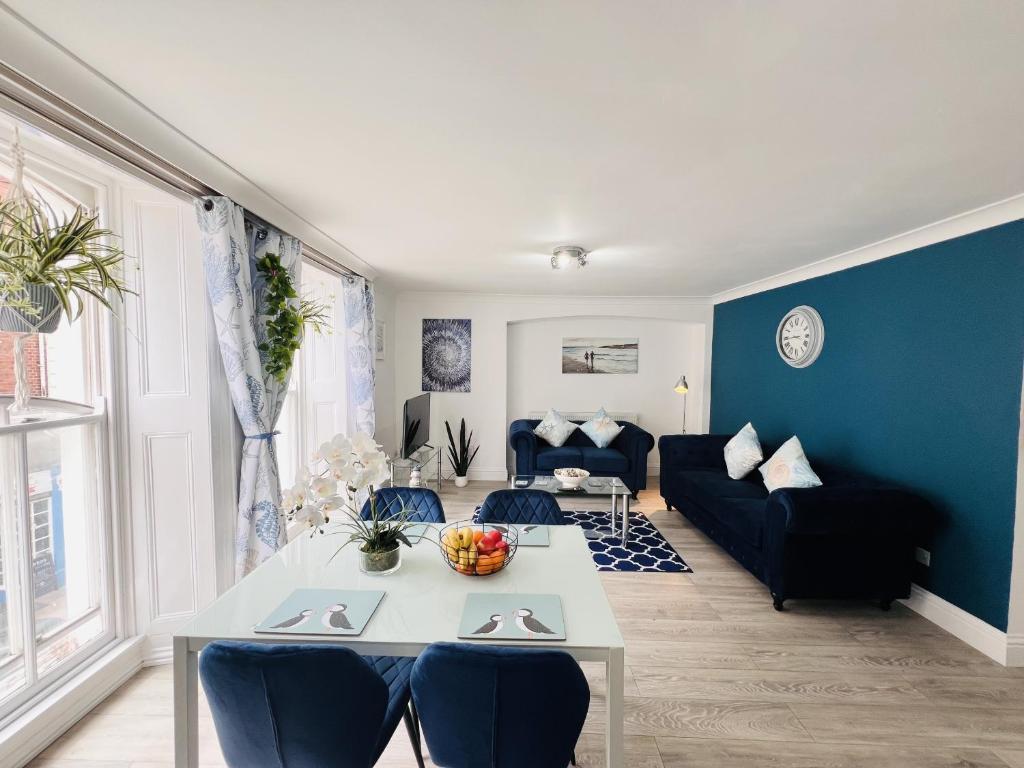 a living room with a table and a couch at The Barbican Apartments in Plymouth