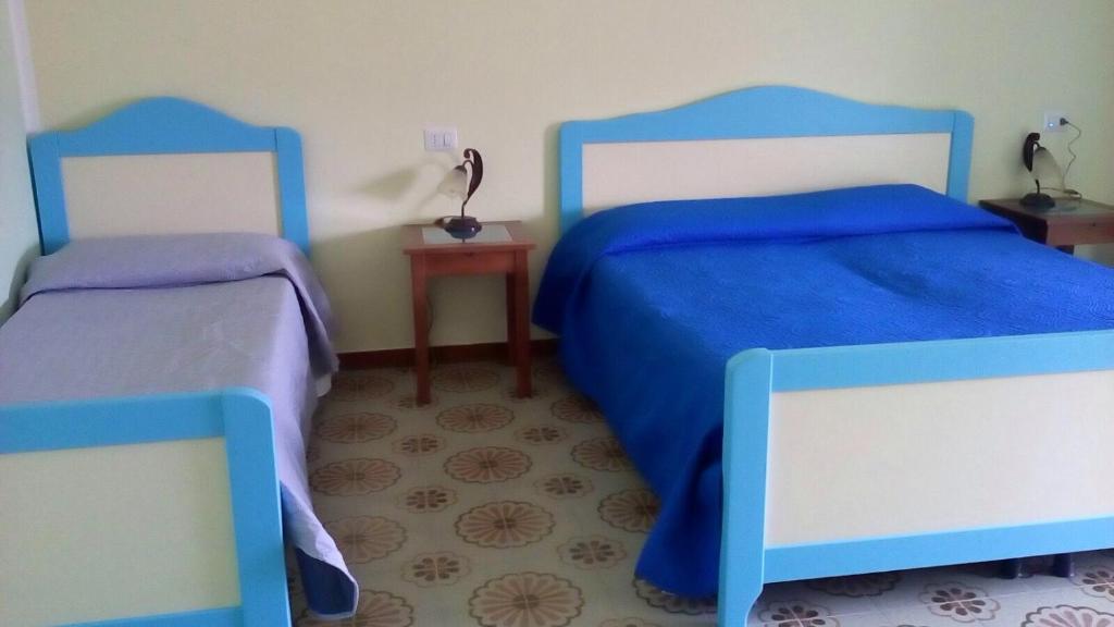 Postel nebo postele na pokoji v ubytování B&b La Scogliera