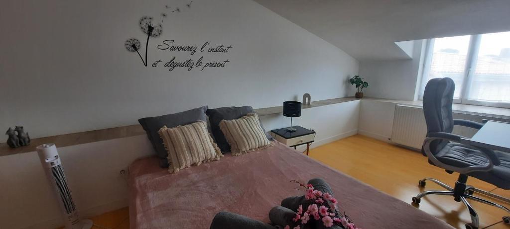 a living room with a bed and a couch at Chambre CHARDON - Maison partagée - 2 personnes in Saint-Sauvant