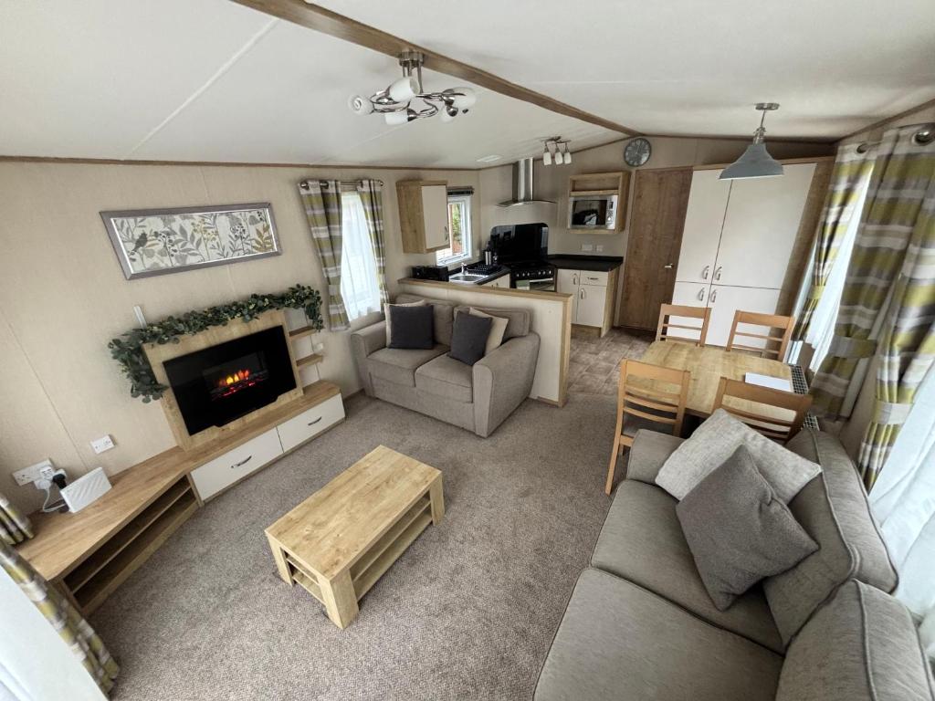 a living room with a couch and a fireplace at Aisling in Stanhope
