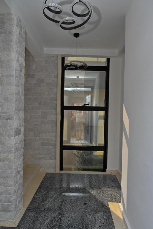 a hallway with a window and a chandelier at Stars Five Stay in Ulcinj