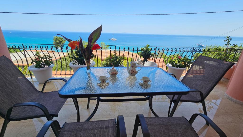 a blue table and chairs with a view of the ocean at Georgia's Skyview in Póros Kefalonias