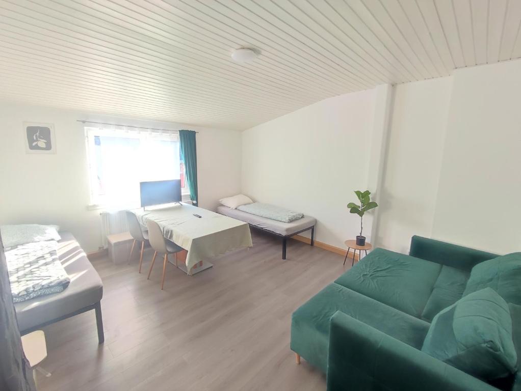 a living room with a couch and a table at Bright and Spacious Apartment in Wiesbaden City Center in Wiesbaden