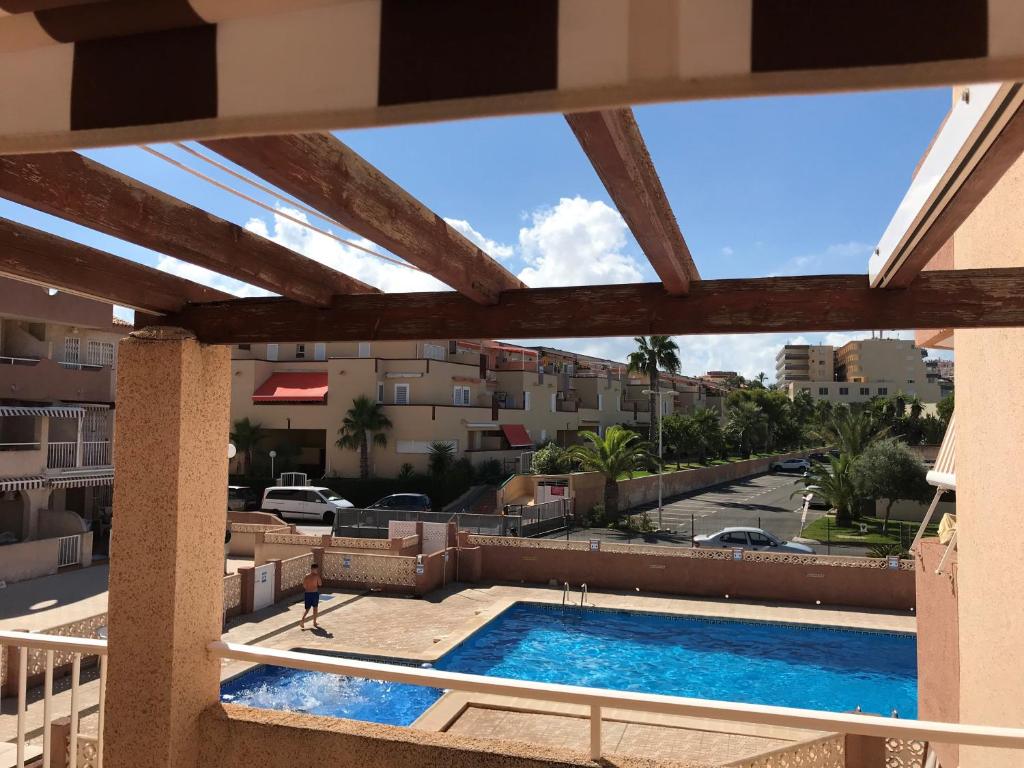 a view of a swimming pool from a balcony at DUPLEX 3 DORMITORIOS en LA MANGA in San Javier