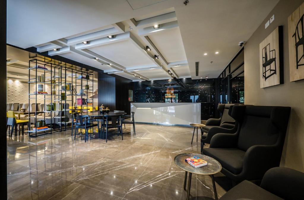 a lobby with chairs and a table in a room at Golden Crown Haifa in Haifa