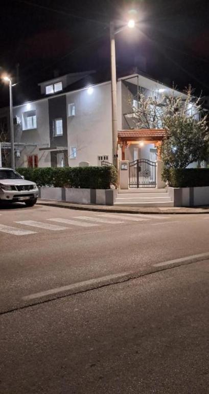 a car parked in front of a house at night at Room Misir in Downtown - Private Entrance and Private Bathroom in Knin