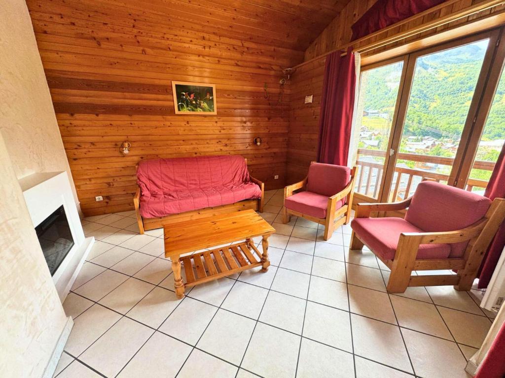 un salon avec deux chaises et une cheminée dans l'établissement Résidence Lupins - 85m2 bien équipé pour 6 personnes à St Martin de Belleville MAE-7334, à Saint-Martin-de-Belleville