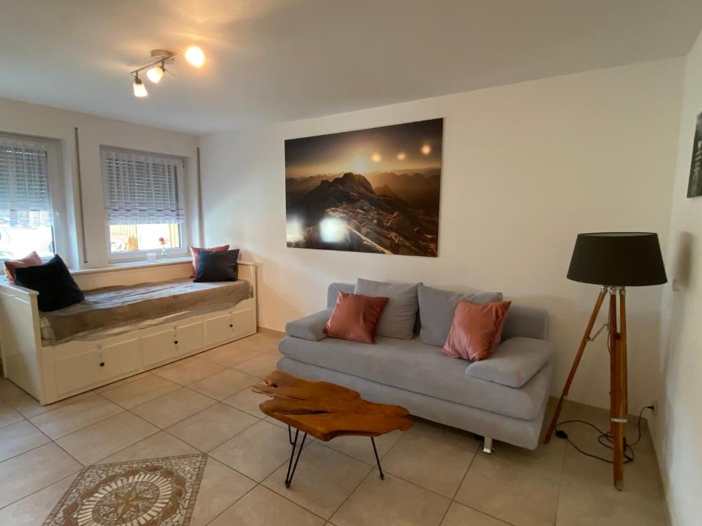a living room with a couch and a window at Ferienwohnung Bergliebe in Füssen