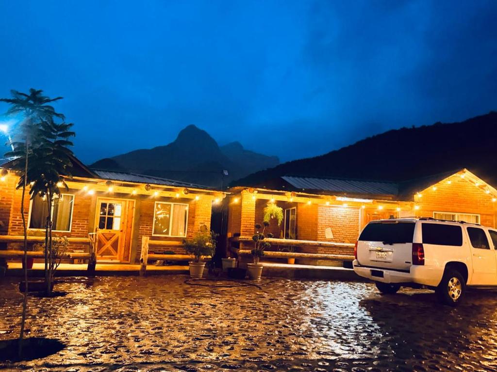 a car parked in front of a house at night at Cabañas Villa Escondida in Urique