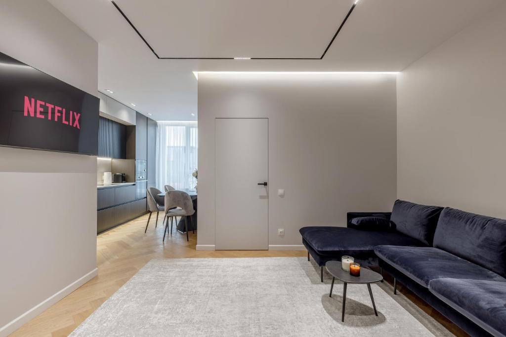 a living room with a couch and a table at Renest Milano Elegance Stay in Chişinău