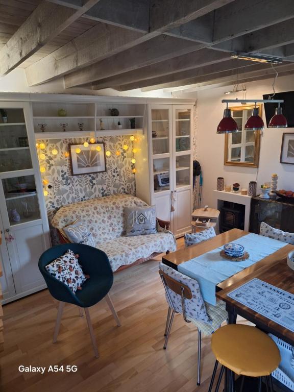 a living room with a bed and a table at Gîte Ô Rendez-vous de la Baie-salle de bien-être- sauna-balnéo in Millencourt-en-Ponthieu