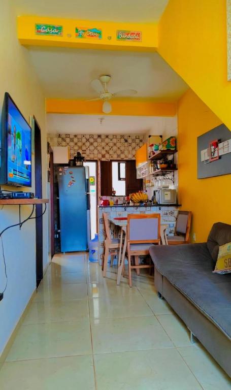 a kitchen and living room with a blue refrigerator at Escapada do Sonho in Lençóis