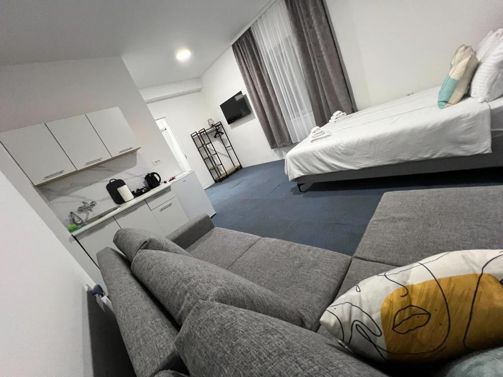 a living room with a couch and a bed at Urban Heart Residence in Sarajevo