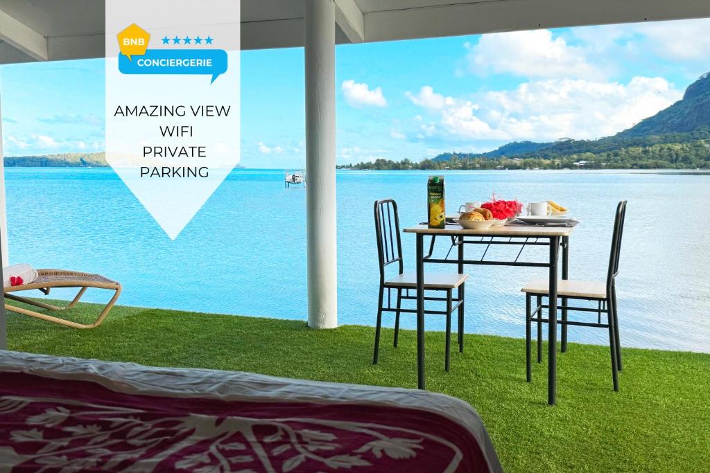 a table and chairs with a view of the water at Lagoon house between sea and mountain, near Vaitape and Matira in Bora Bora