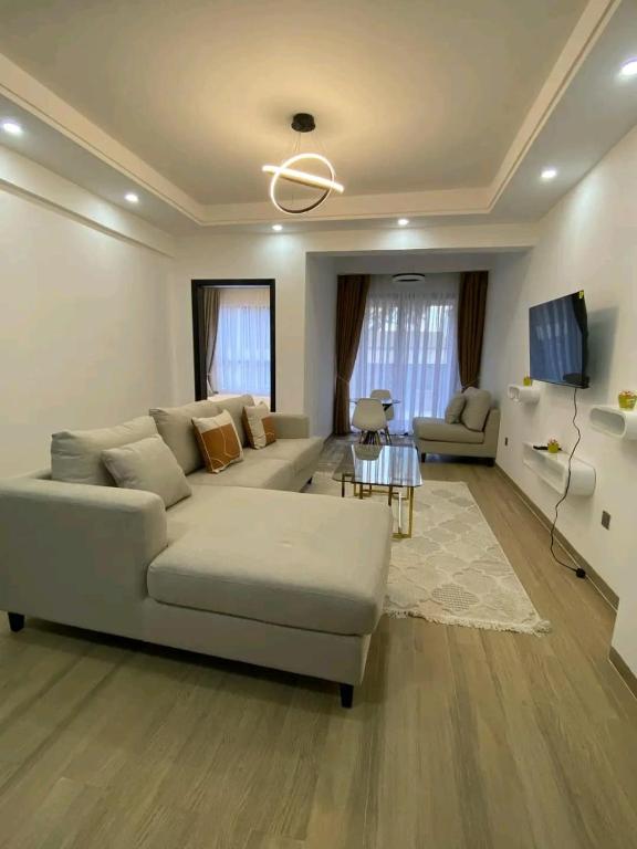 a living room with a couch and a table at Spacious 1Br in Westlands in Nairobi
