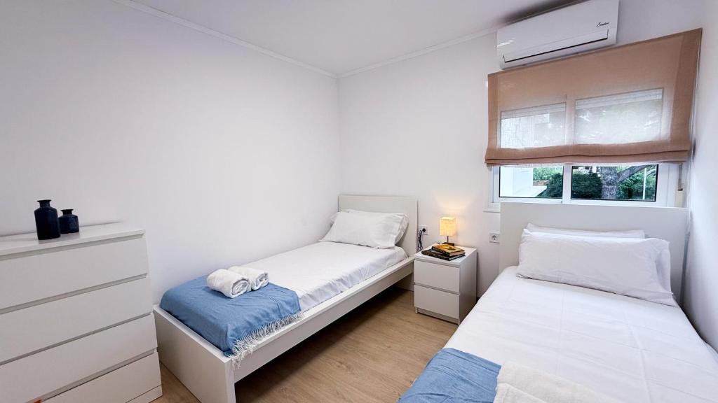 a bedroom with two beds and a window at 109 - Beachside Renovated 1BR apt 5 min from Beach in Cambrils