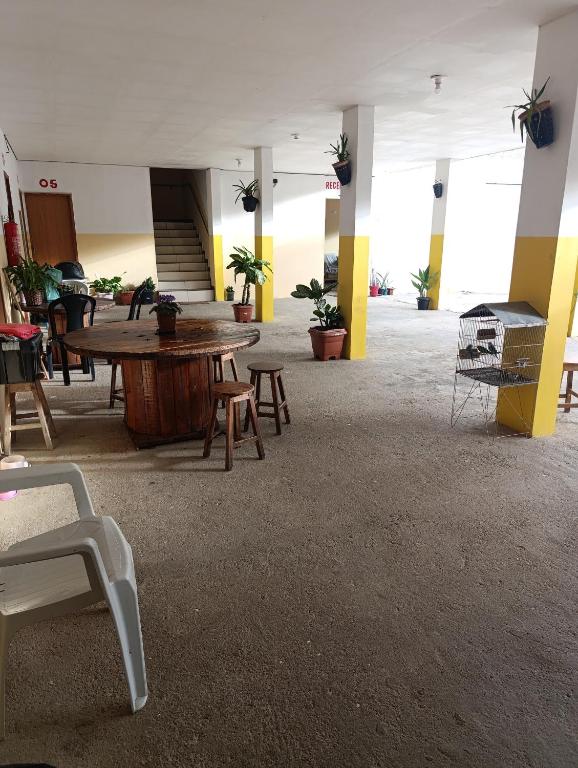 a large room with tables and chairs in a building at Hotel Atalaia in Vitória da Conquista