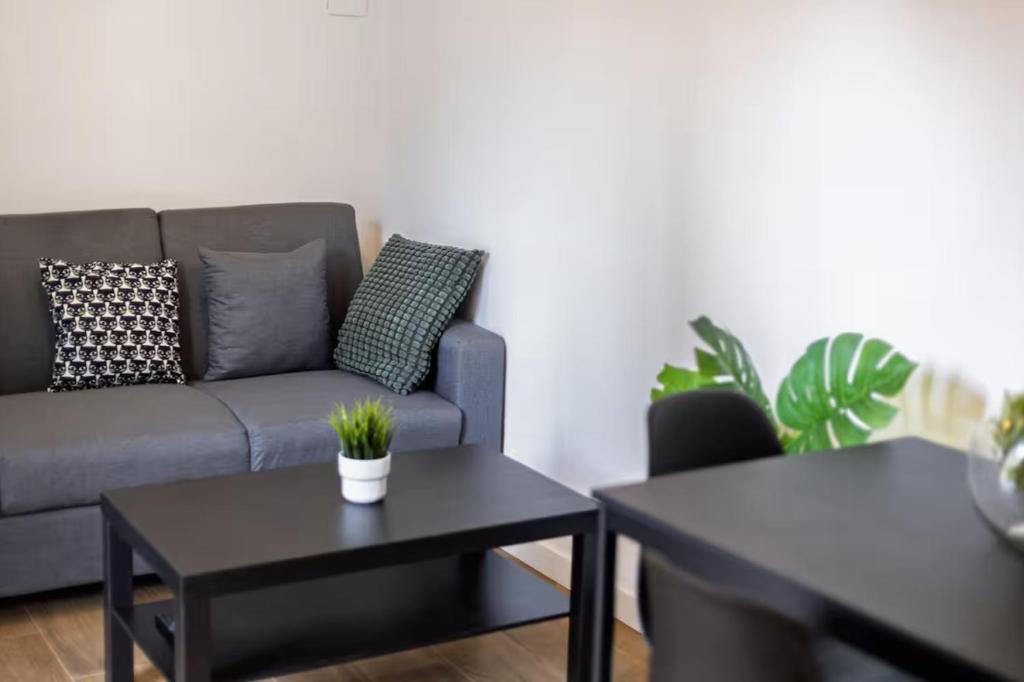 a living room with a couch and two tables at Quiet & Modern Apartment in Valencia